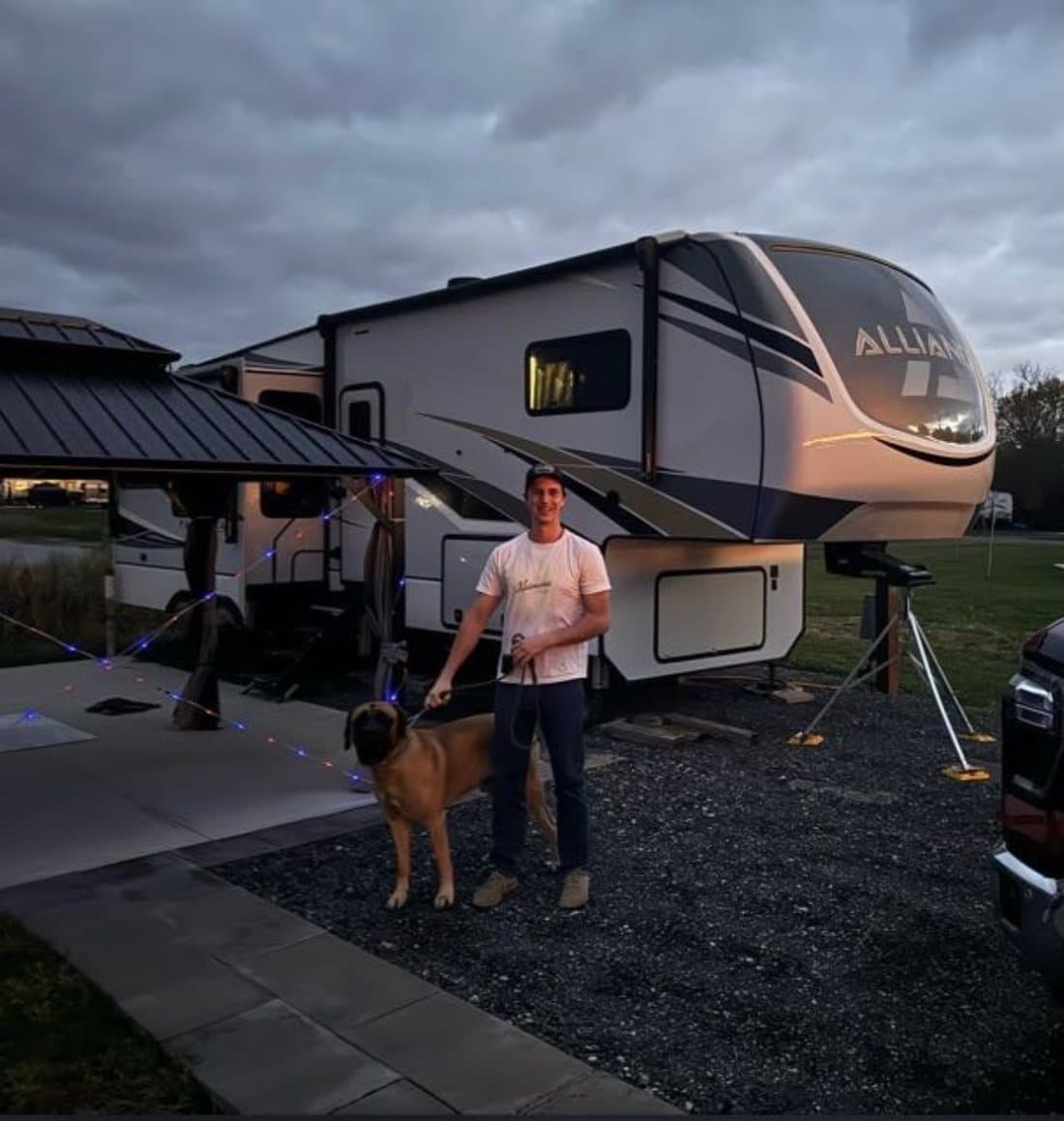 Gregory Candeur, founder of FullSite, with his fifth wheel and dog at dusk